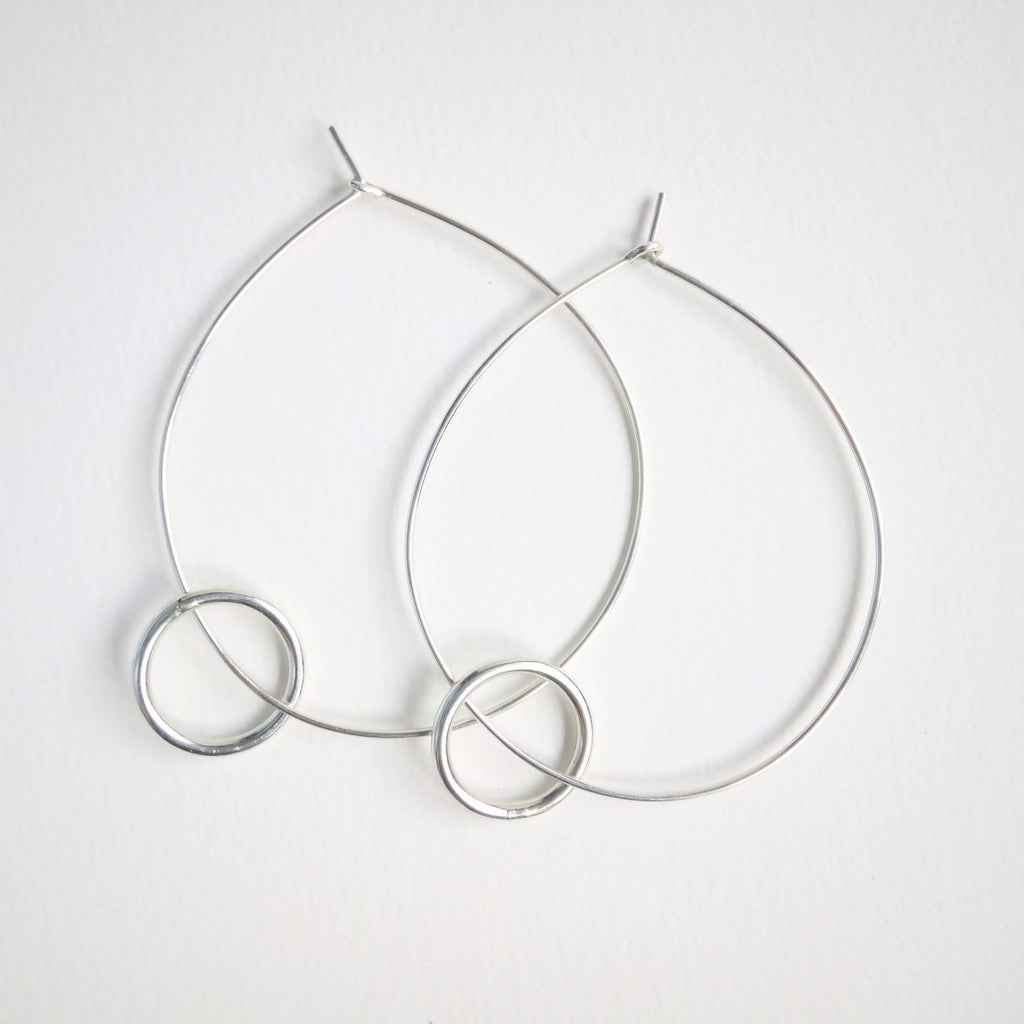 Small wider hoop on large fine hoop. The small wide hoop moves around the large. Large hoop 5cm small hoop 1.5cm