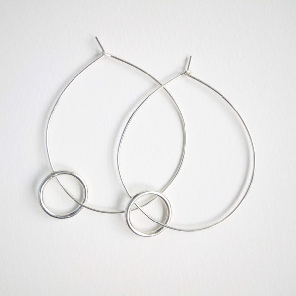 Small wider hoop on large fine hoop. The small wide hoop moves around the large. Large hoop 5cm small hoop 1.5cm