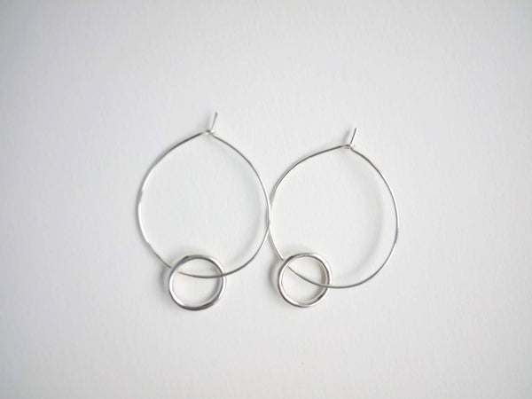 Small wider hoop on large fine hoop. The small wide hoop moves around the large. Large hoop 5cm small hoop 1.5cm