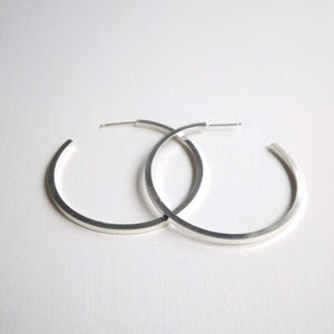 Chunky square wire hoops around 3.5cm round, on stud setting.