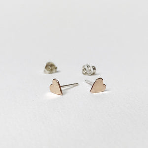Gold filled hearts on sterling silver studs. Gold filled means sterling silver coated in a thick coating of gold.