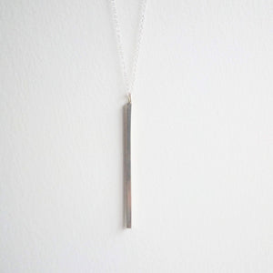 A 4cm long bar of solid silver hangs on a fine sterling silver chain