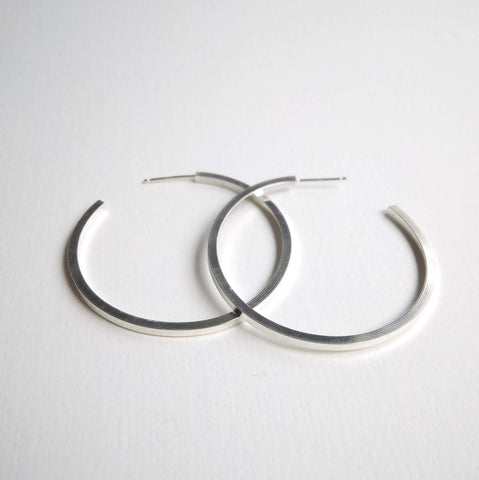Chunky square wire hoops around 3.5cm round, on stud setting.
