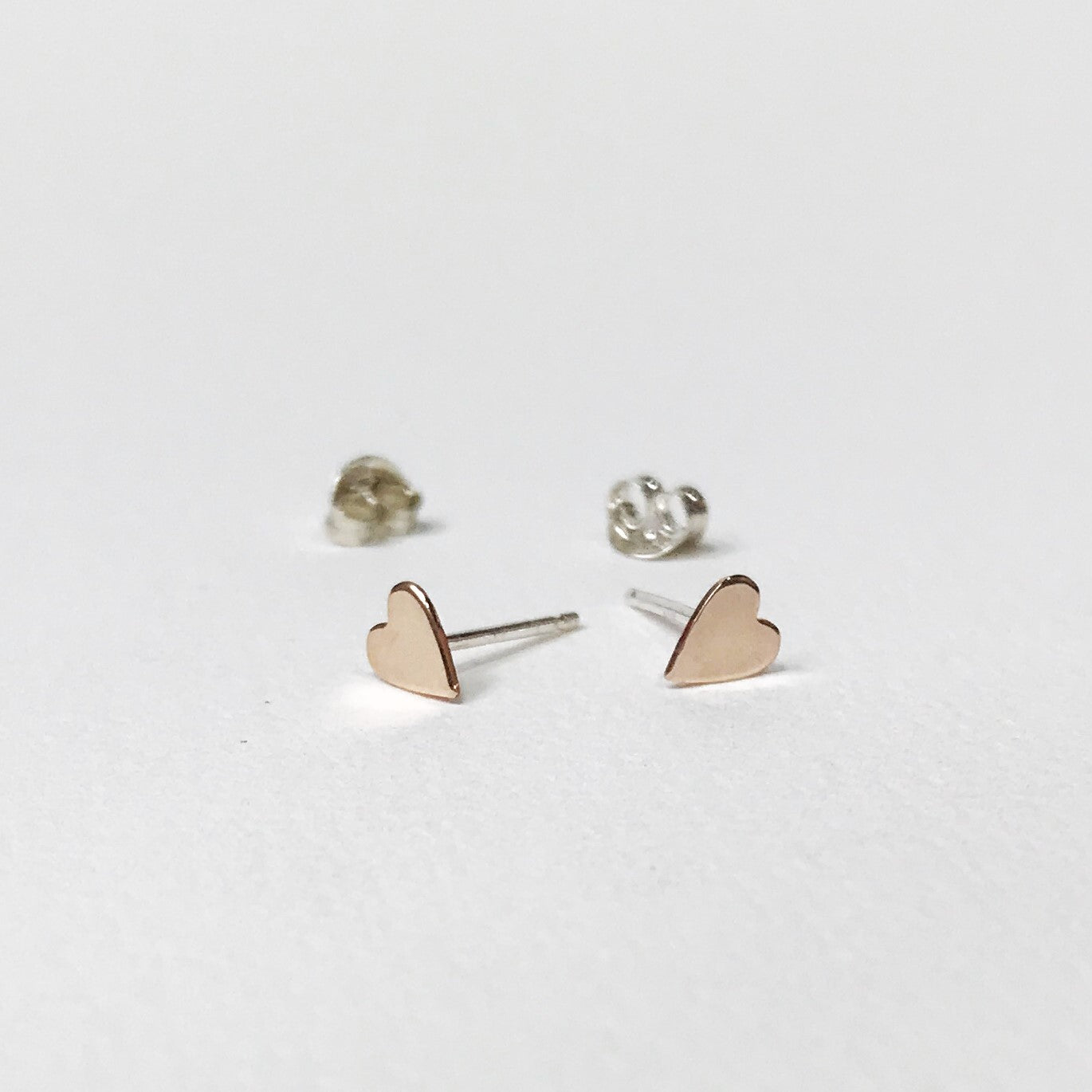 Gold filled hearts on sterling silver studs. Gold filled means sterling silver coated in a thick coating of gold.