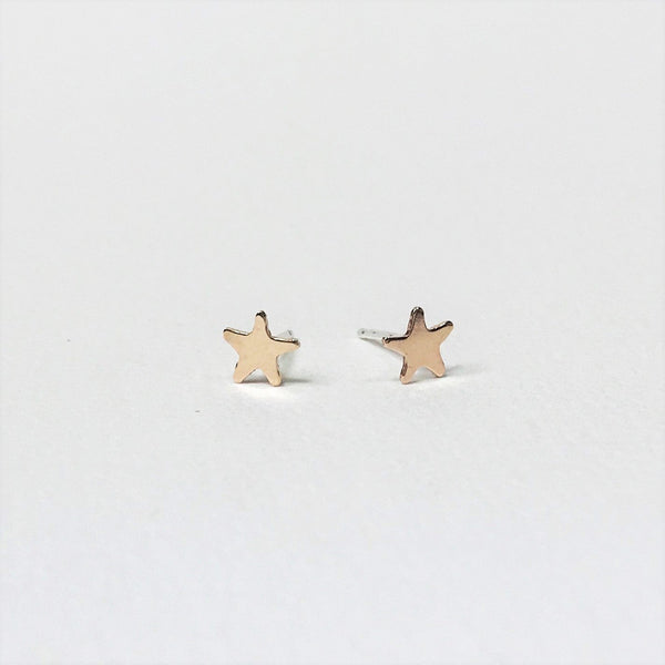 Tiny gold stars on sterling silver studs. Gold filled - sterling silver coated in a thick coating of gold. 